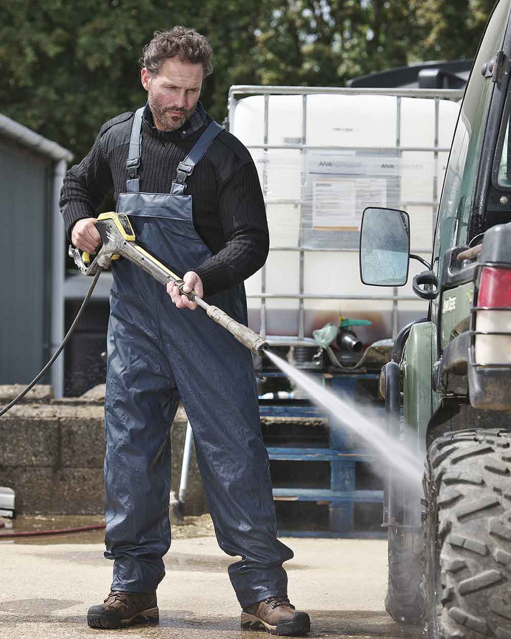 Navy coloured Fort Airflex Waterproof Breathable Bib and Brace Overalls on blurry background