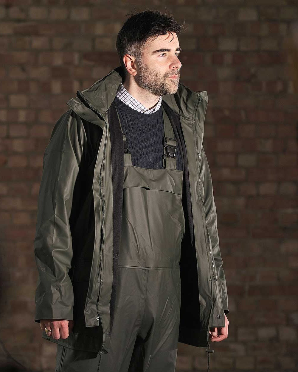 Olive coloured Fort Airflex Waterproof Breathable Bib and Brace Overalls on blurry background