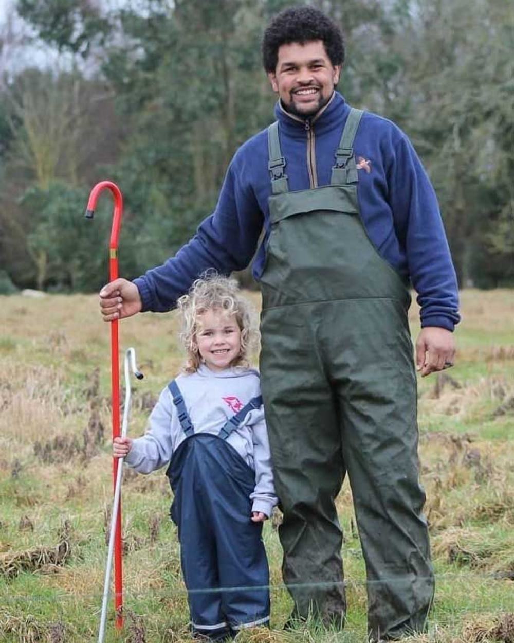 Olive coloured Fort Airflex Waterproof Breathable Bib and Brace Overalls on blurry background