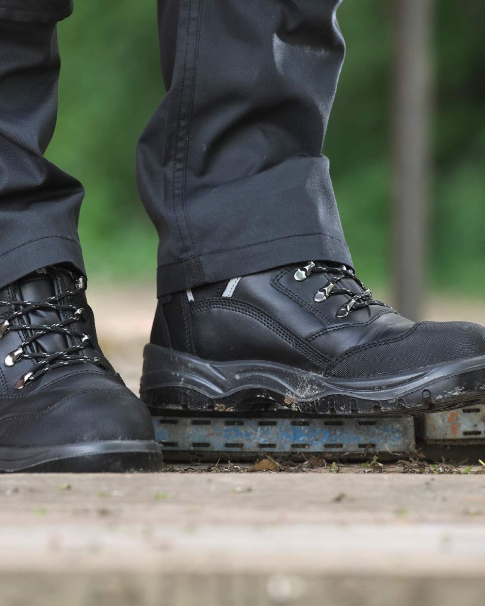 Black coloured Fort Knox Safety Boots on blurry background