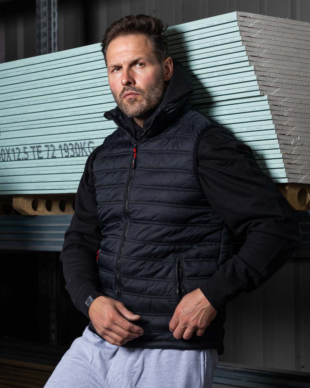 Black Coloured TuffStuff Elite Bodywarmer On A Factory Background
colour_black