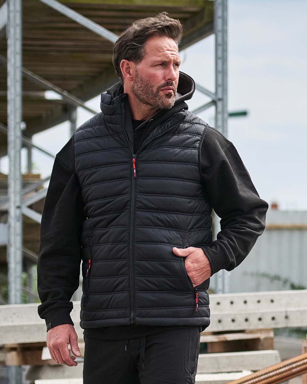 Black Coloured TuffStuff Elite Bodywarmer On A Factory Background
colour_black