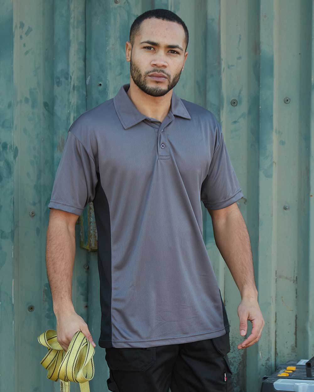 Grey Coloured TuffStuff Elite Polo Shirt On A Teen Sheet Background