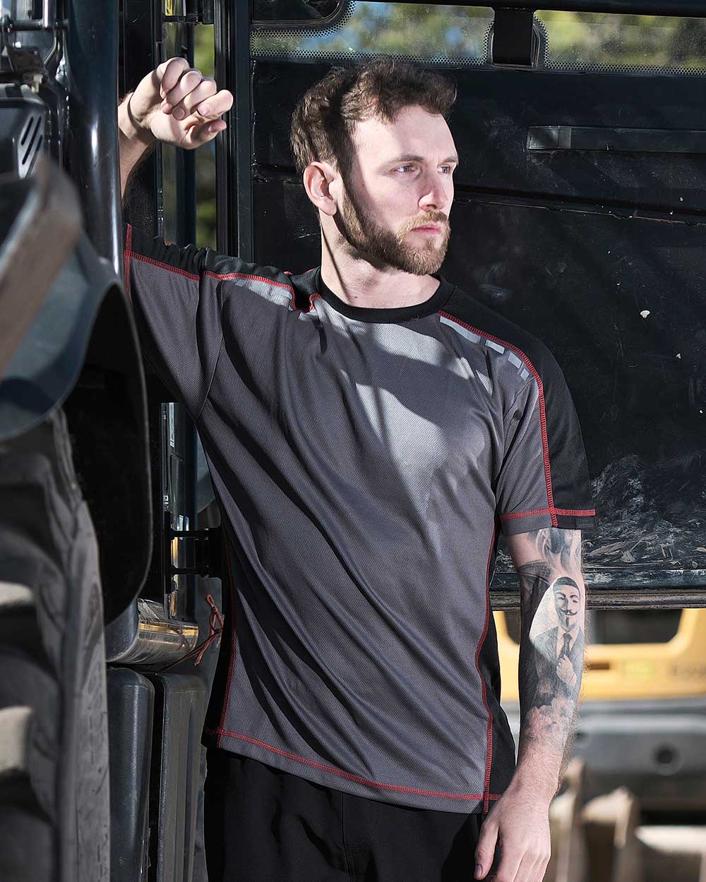 Grey Coloured TuffStuff Elite T-Shirt On A Car Background