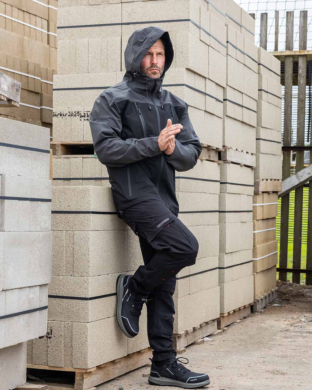 Black coloured TuffStuff Evo Flex Trousers on outdoor background