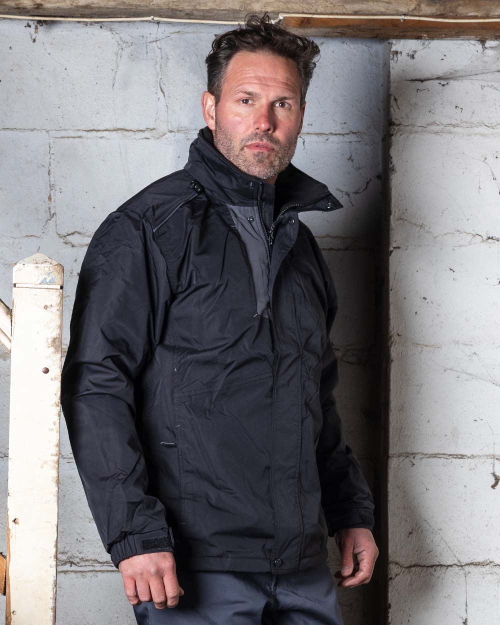 Black Coloured TuffStuff Newport Jacket On A Warehouse Background