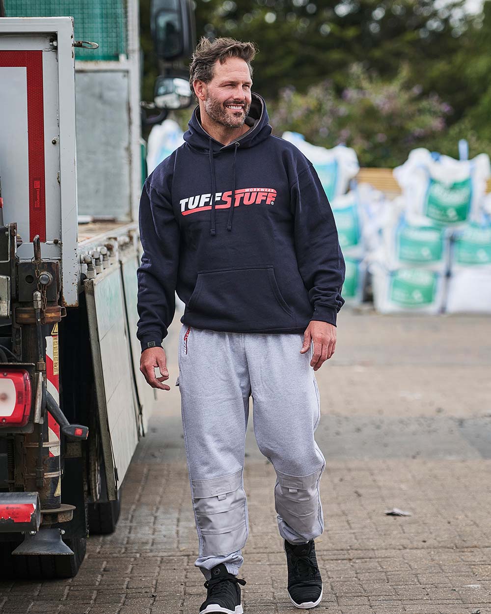 Grey Coloured TuffStuff Comfort Work Trouser On A Factory Background