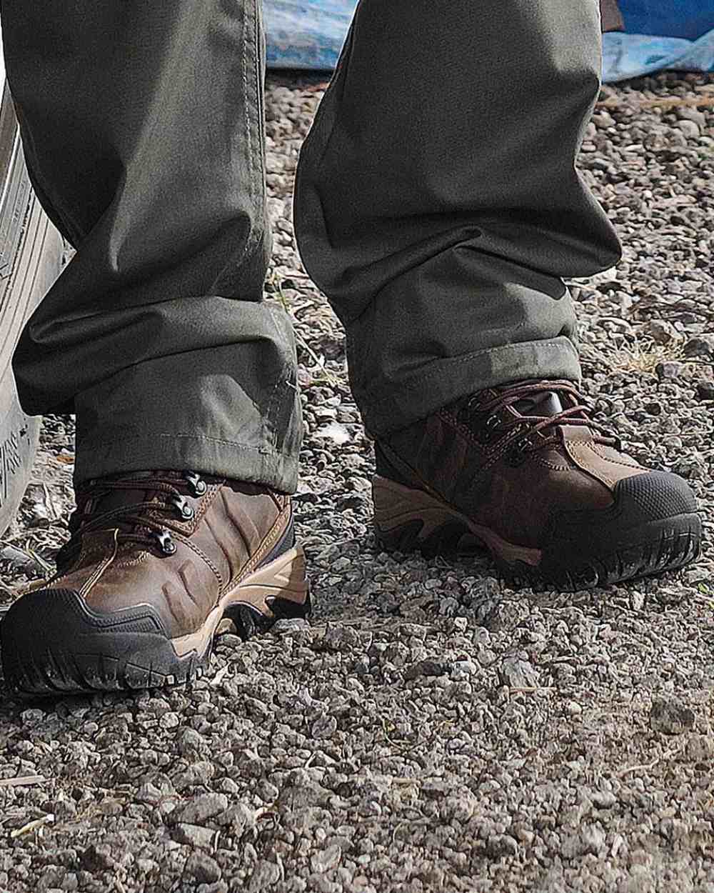 Brown Coloured Fort Deben Waterproof Safety Boot On A Concrete Road Background