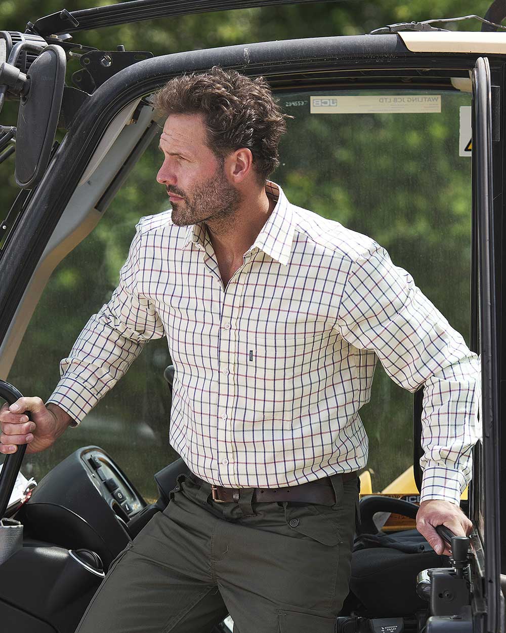 Farmer on tractor wearing Fort Melton Tattersall Check Shirt