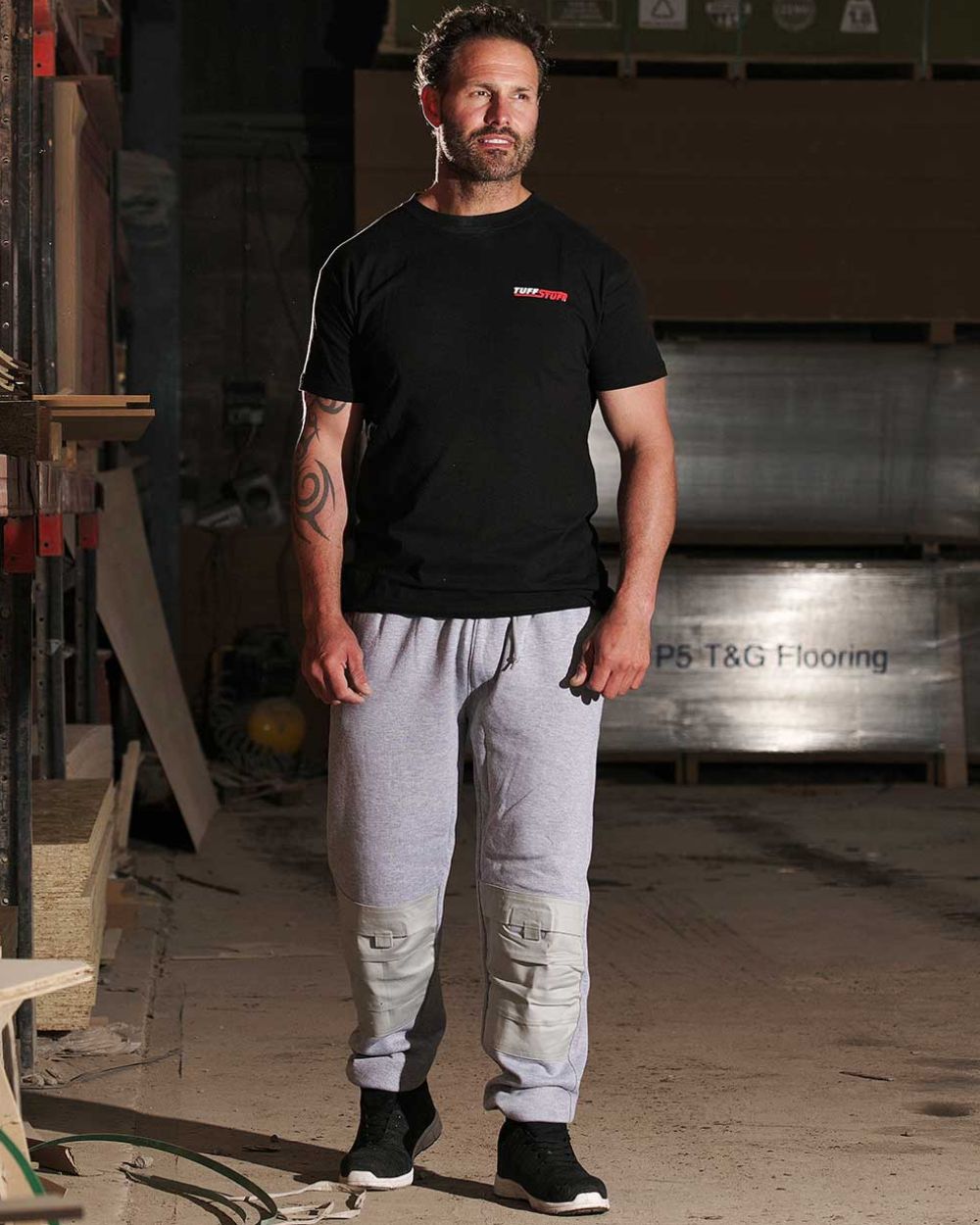 Grey Coloured TuffStuff Comfort Work Trouser On A Factory Background