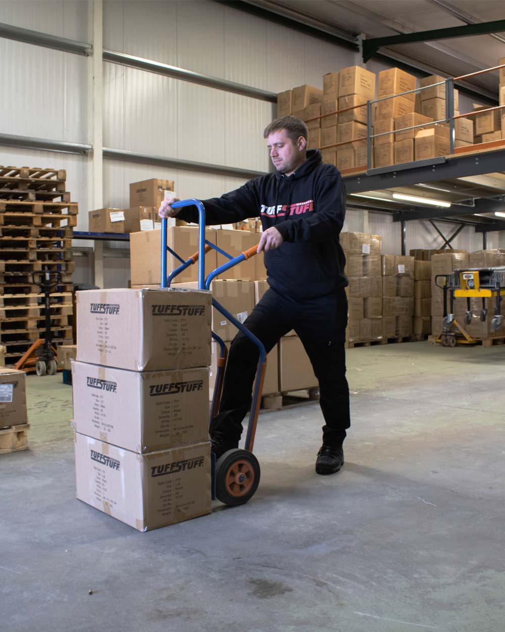 Black coloured TuffStuff Logo Hoodie on Warehouse background