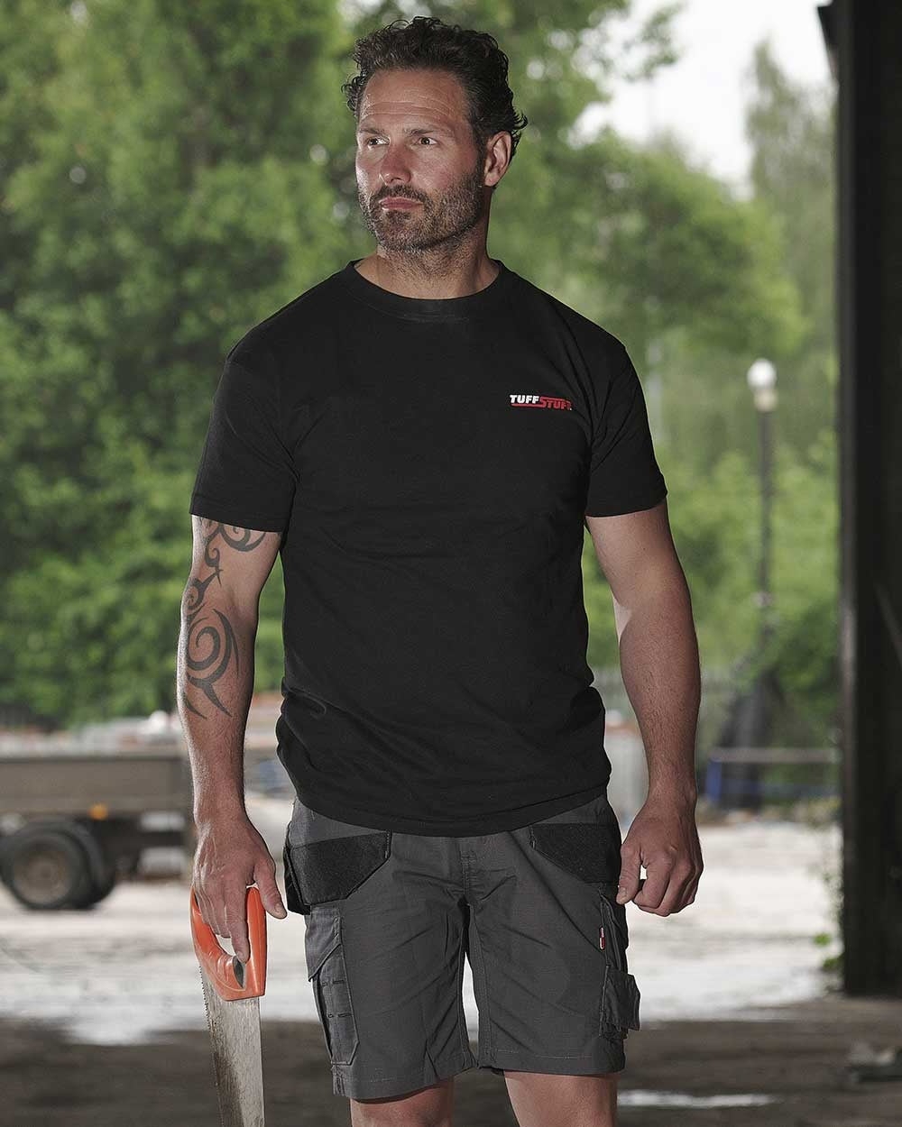 Black coloured TuffStuff Logo T-Shirt on construction background