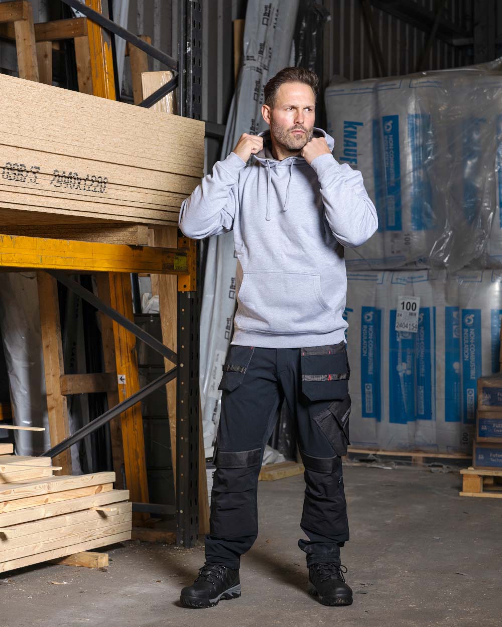 Black TuffStuff Apex Flex Trousers in a warehouse background

