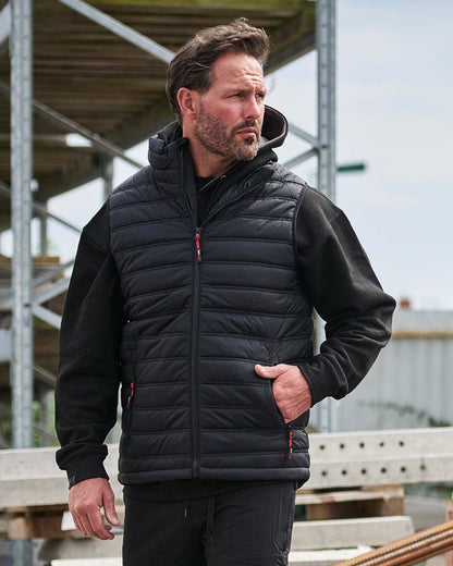 Black Coloured TuffStuff Elite Bodywarmer On A Factory Background
colour_black
