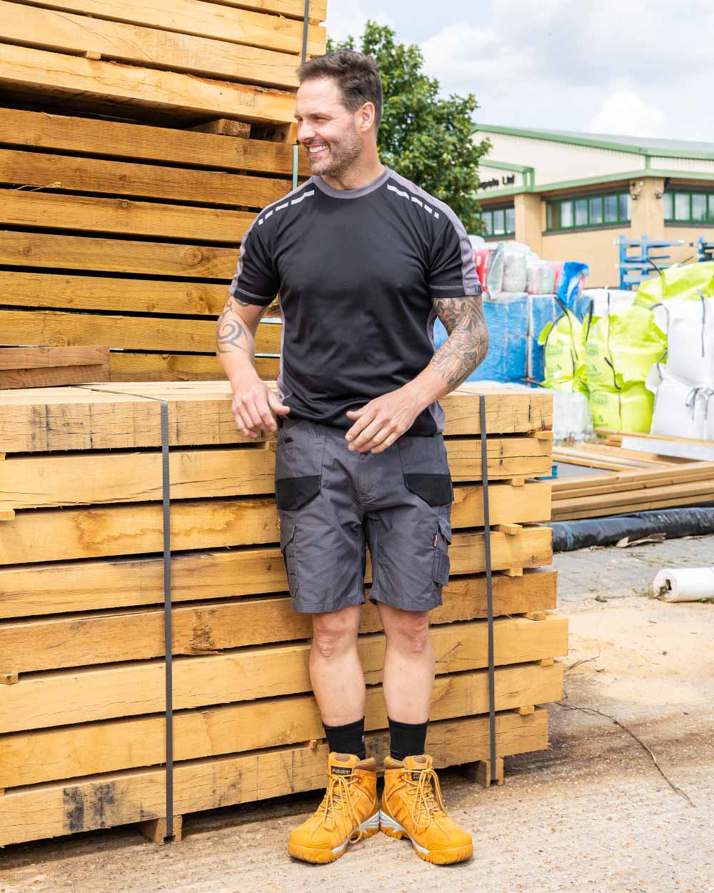 Grey Coloured TuffStuff Elite Work Shorts On A Warehouse Background