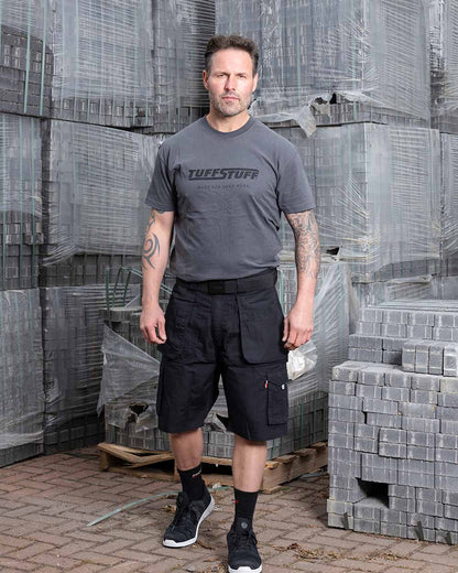 Black Coloured TuffStuff Enduro Work Shorts On A Warehouse Background 