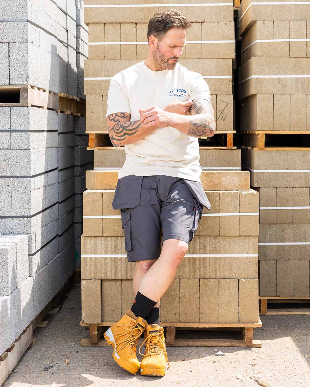 Grey Coloured TuffStuff Enduro Work Shorts On A Warehouse Background 