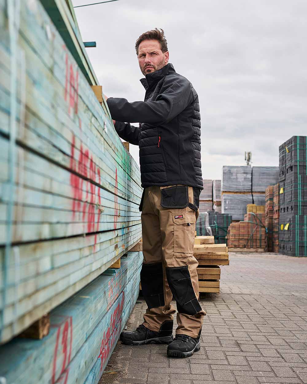 Stone Coloured TuffStuff Excel Work Trousers On A Warehouse Background 