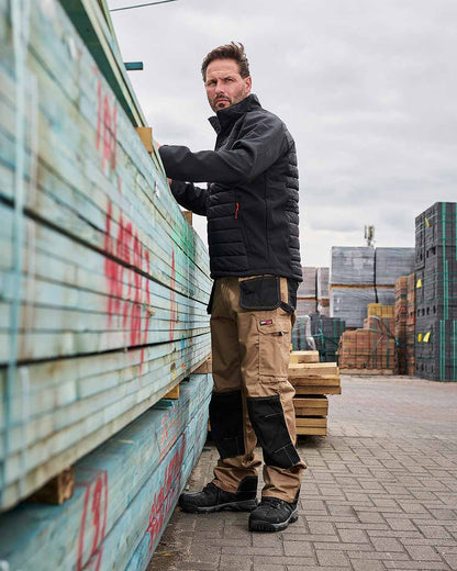Stone Coloured TuffStuff Excel Work Trousers On A Warehouse Background 