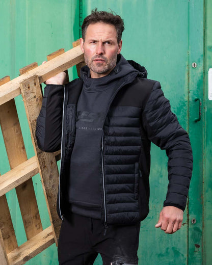 Black Coloured TuffStuff Hatton Soft Shell Jacket On A Warehouse Background