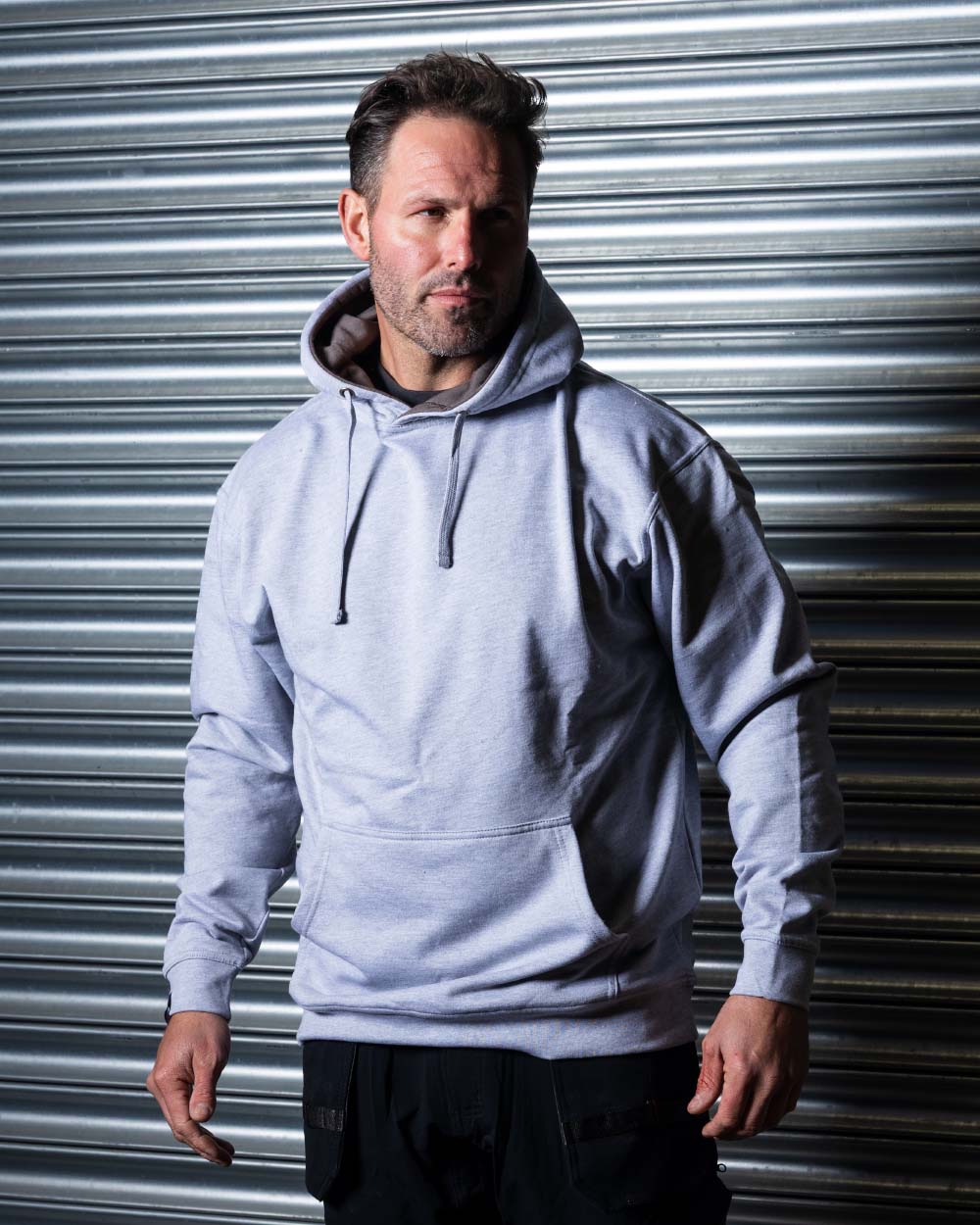 Grey Coloured TuffStuff Hendon Hoodie On A Warehouse Background 