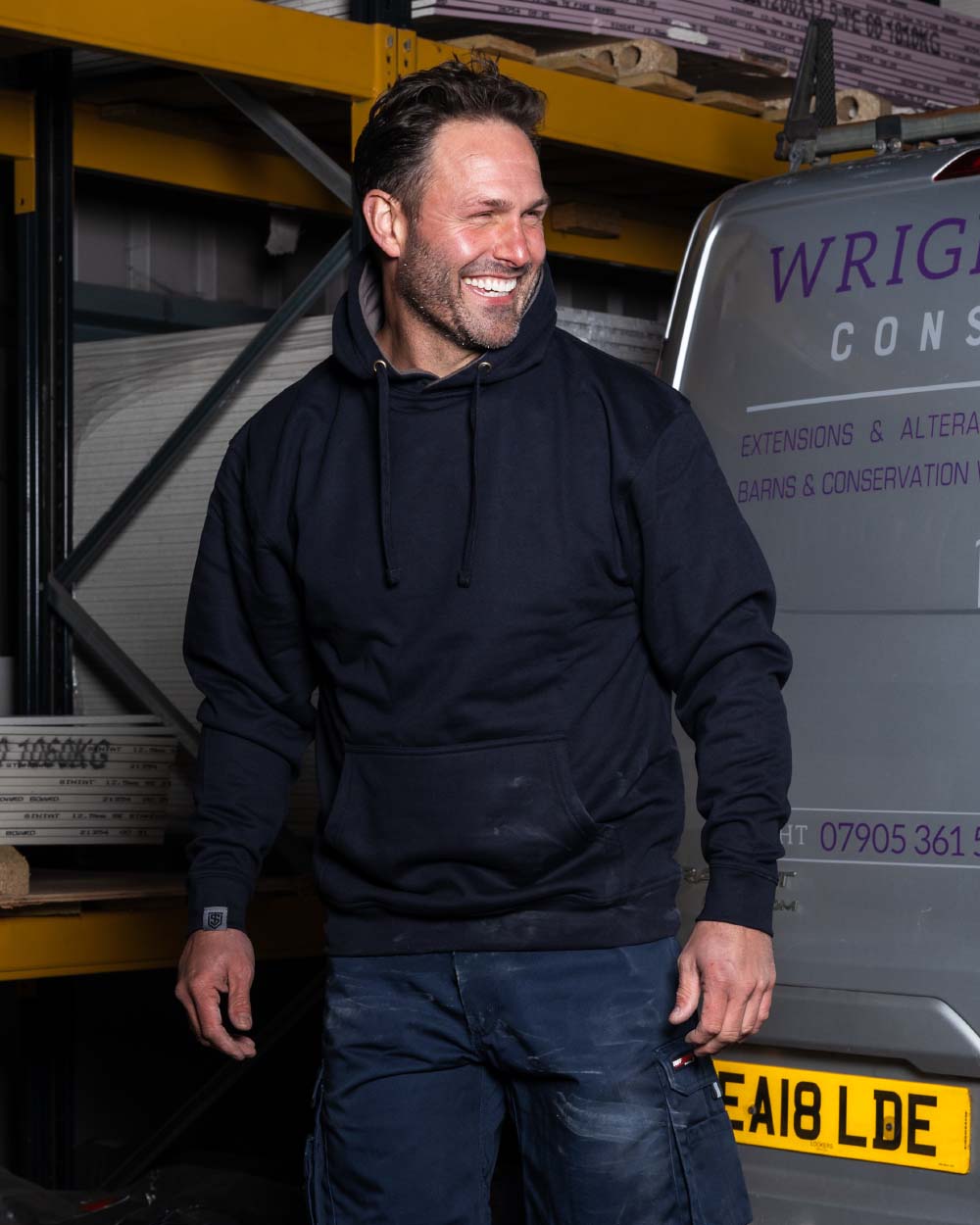 Navy Coloured TuffStuff Hendon Hoodie On A Warehouse Background 