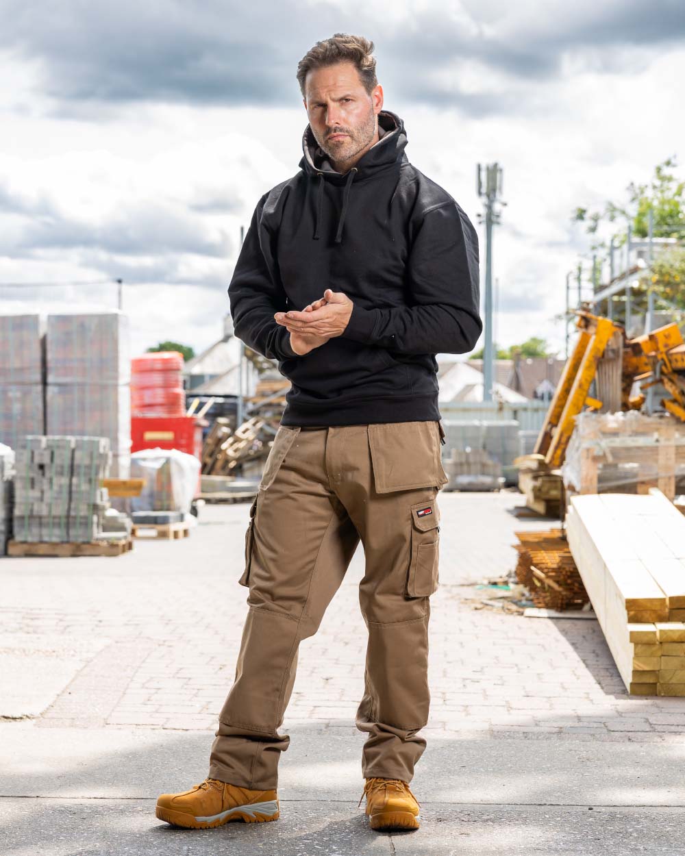 Stone Coloured TuffStuff Pro Work Trousers On A Warehouse Background 