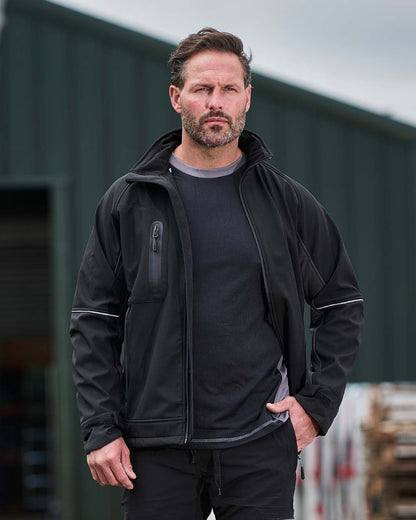 Black Coloured TuffStuff Stanton Waterproof Softshell Jacket On A Warehouse Background 
