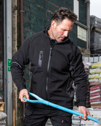 Black Coloured TuffStuff Stanton Waterproof Softshell Jacket On A Warehouse Background 