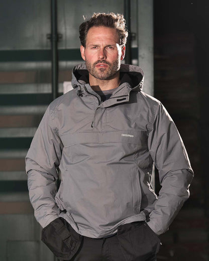 Grey Coloured TuffStuff Sutherland Waterproof Windbreaker Smock On A Factory Background 