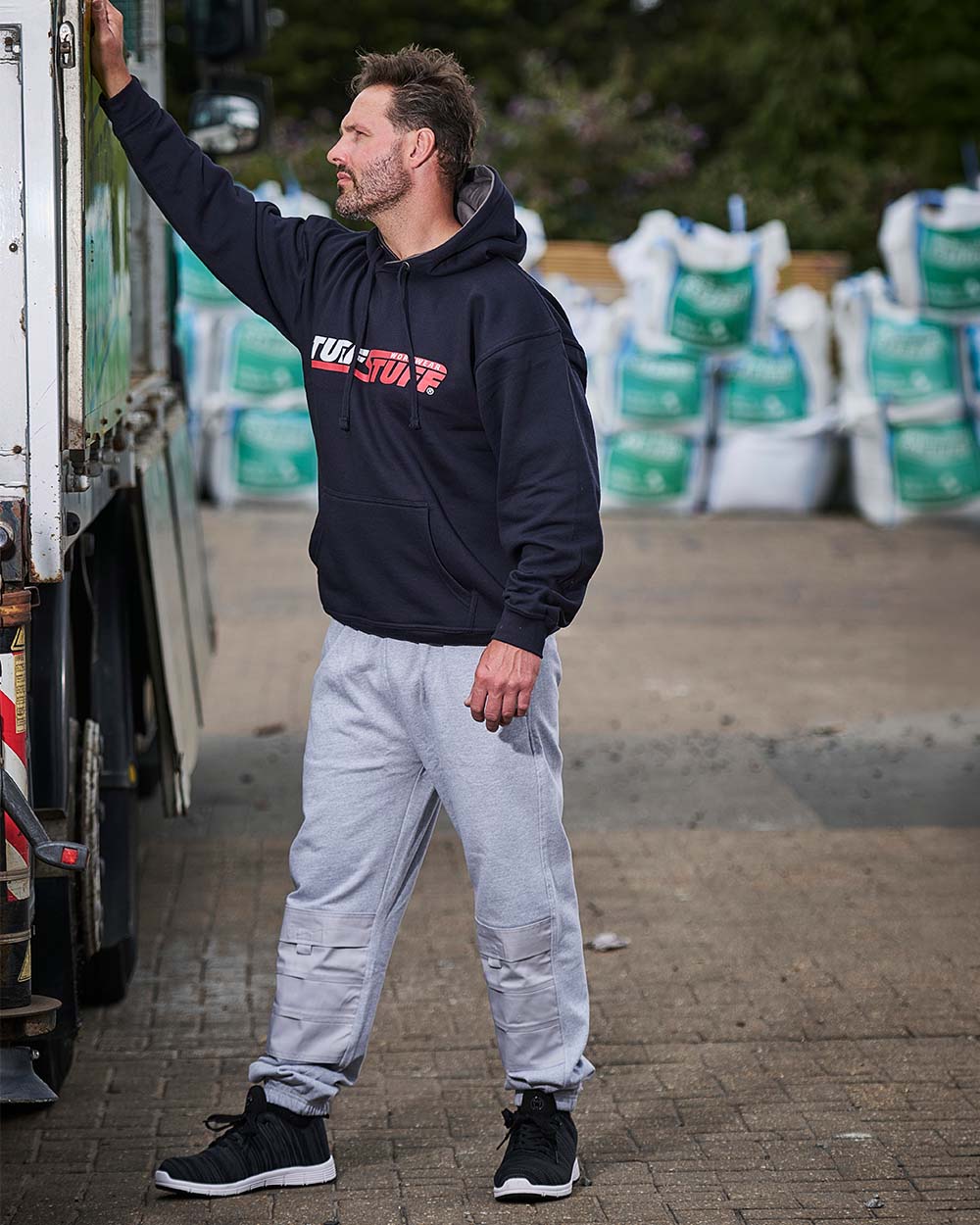 Grey Coloured TuffStuff Comfort Work Trouser On A Factory Background 