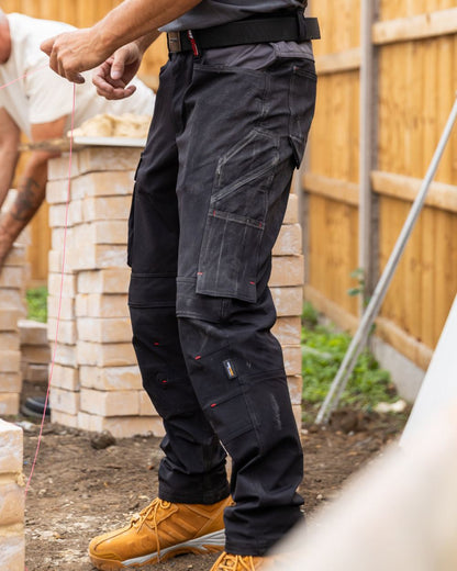 Black coloured TuffStuff Evo Flex Trousers on outdoor background 