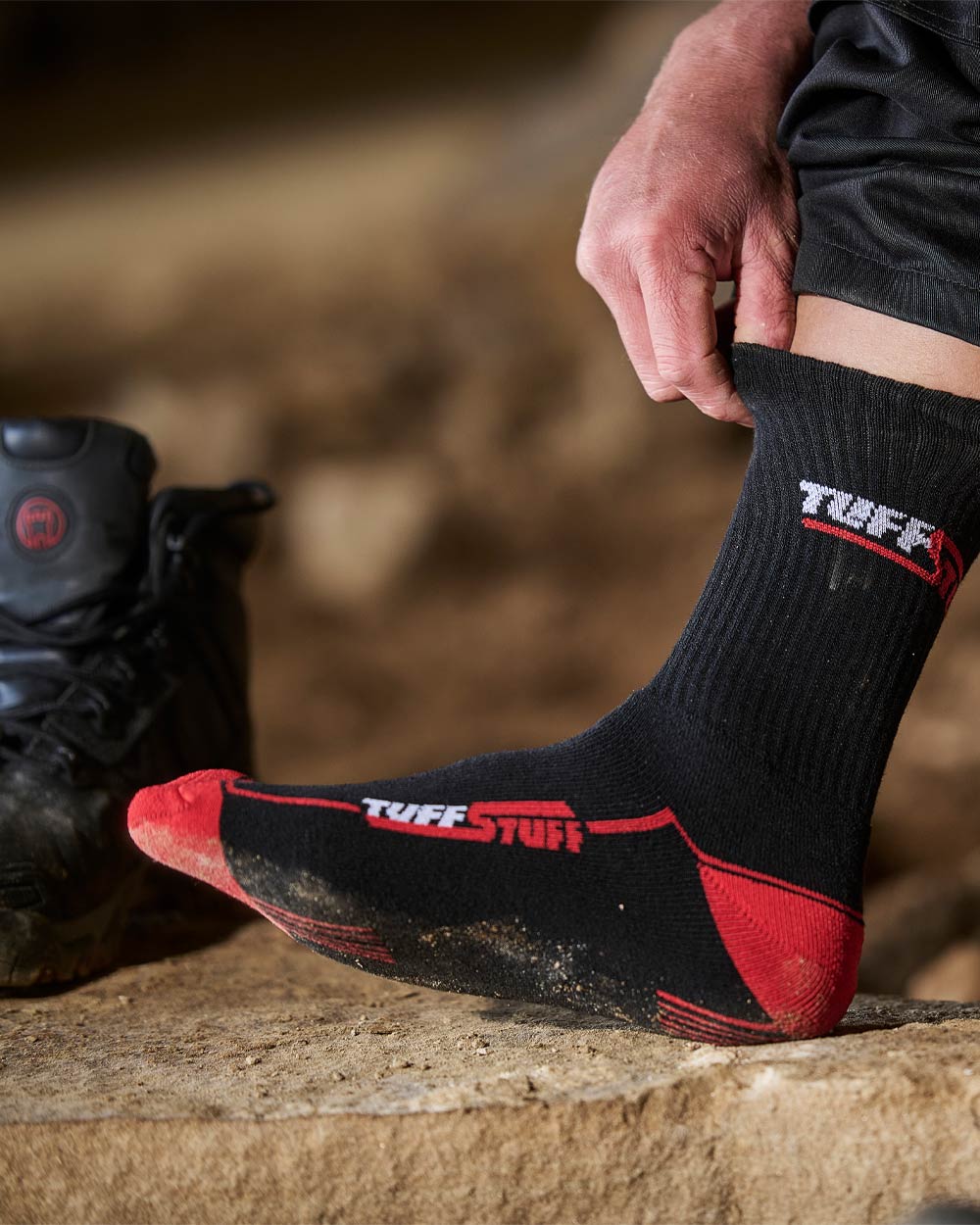 Person wearing Black / Red coloured TuffStuff Extreme Socks with a blurred background