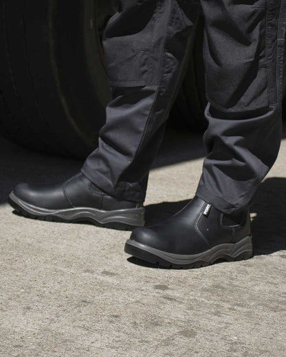 Black Coloured Fort Nelson Safety Dealer Boots On A Street Background 